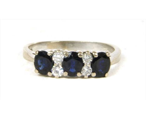 A white gold seven stone sapphire and diamond ring, oval mixed cut sapphires with pairs of brilliant cut diamonds between, cl