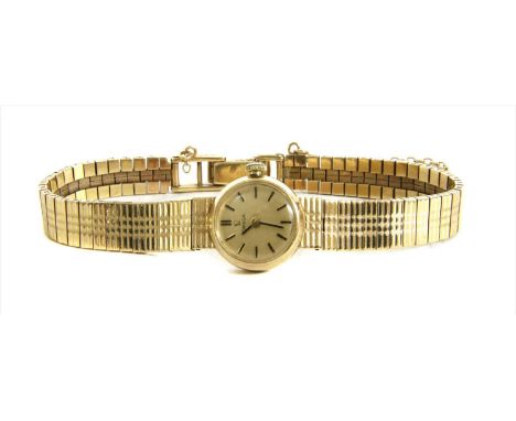 A ladies' 9ct gold Omega mechanical bracelet watch, c.1960, 17mm diameter with a champagne dial and black and gilt baton mark