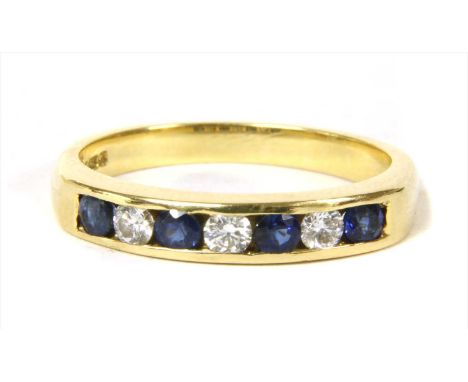 An 18ct gold diamond and sapphire half eternity ring, alternating brilliant cut diamonds and circular mixed cut sapphires, ch
