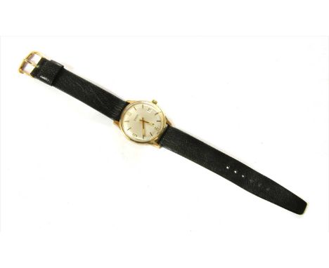 A gentlemen's 9ct gold Garrard automatic strap watch, c.1970, 35mm diameter, with a silvered dial, baton hour markers with Ar