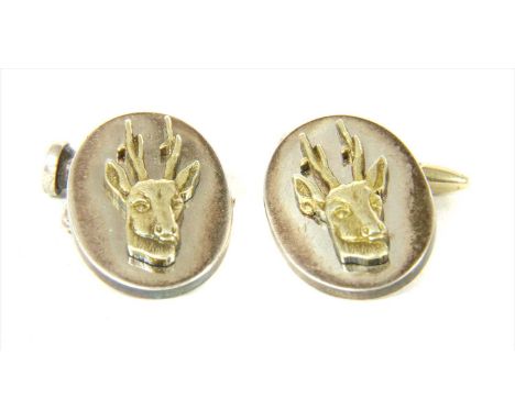 A pair of silver gilt stag cufflinks, by Holland &amp; Holland, a silver oval flat section plate with applied silver gilt sta