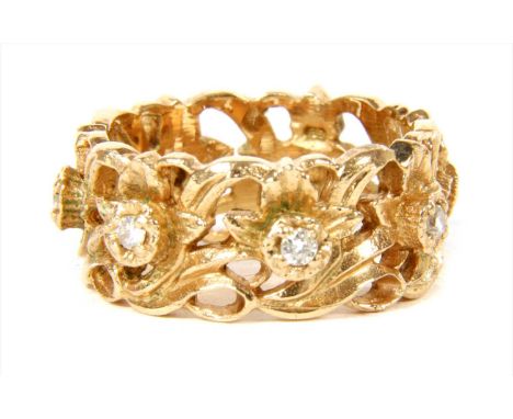 A 14ct gold diamond ring, the openwork foliate band, claw set with brilliant cut diamonds. Import hallmark London. 6.62g Fing