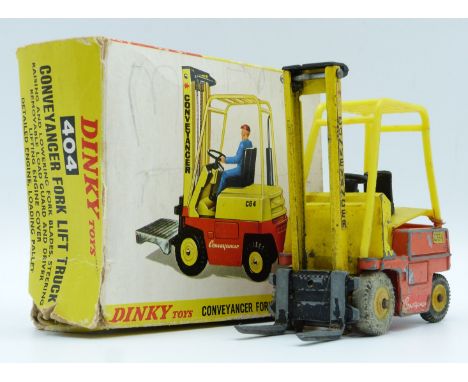 Dinky Toys diecast model Conveyancer Fork Lift Truck with yellow and orange body and yellow hubs, 404, in original box