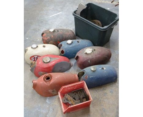 Seven motorbike petrol tanks and engine plates