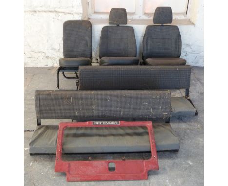 Land Rover Defender seats and parts comprising two bench seats, three further seats, front panel and trim panels