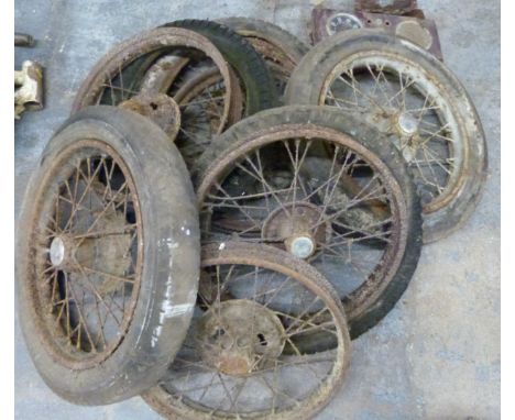 Six Austin Seven wheels comprising an early 6 inch braked example, three examples with Austin script to centre and two later 