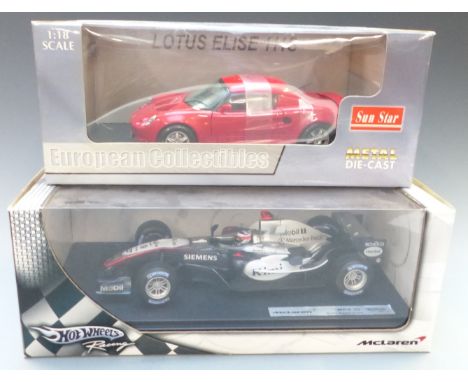 Two 1:18 scale diecast model vehicles Sun Star Lotus Elise 111S 1032 and Hot Wheels Racing McLaren MP4-20, both in original d