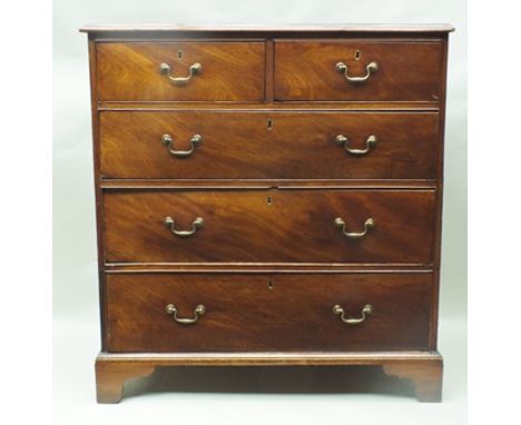 A 19TH CENTURY MAHOGANY FINISHED FIVE DRAWER CHEST having plain top over two in-line and three full width drawers with cast b