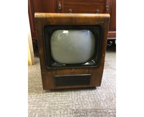 A BAKELITE BLACK &amp; WHITE TELEVISION by Ecko contained within a walnut veneered case - circa 1947. (Sold as a collector's 