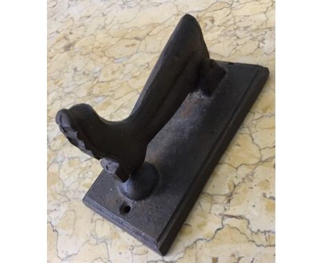 A NOVELTY CAST IRON DOOR KNOCKER in the form of a WELLINGTON  BOOT.