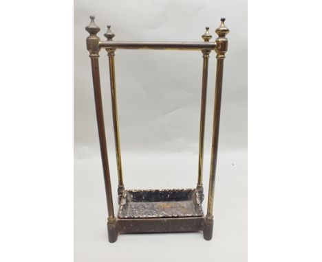 A LATE 19TH/EARLY 20TH CENTURY BRASS STICK STAND having four turned finials and six compartmentalised divisions, having iron 