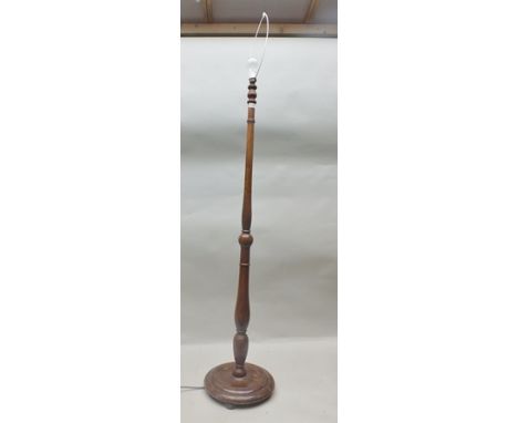 A STAINED WOOD STANDARD LAMP of turned stem design, with cream shade 