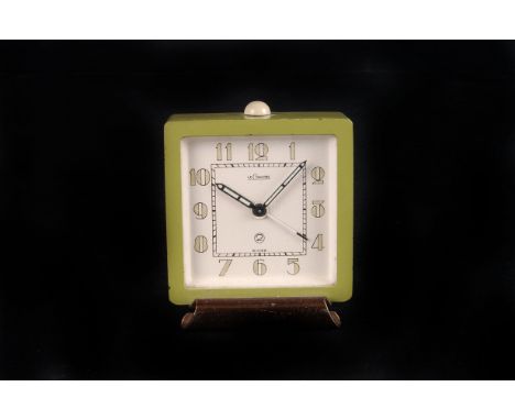 An Art Deco Jaeger LeCoultre travelling alarm clock, in lime green square case, with coppered base, 5.5cm wide
Some small los