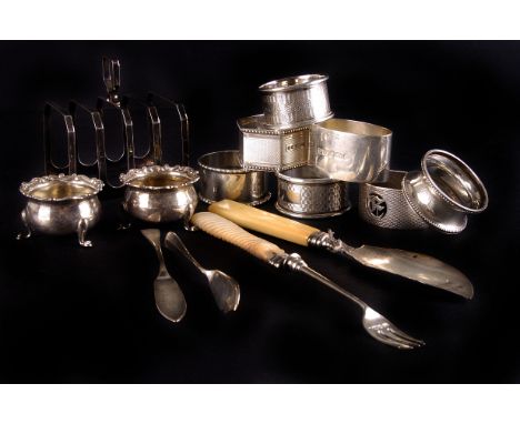A collection of small silver,  including a four division toast rack by Elkington & Co., a group of silver napkin rings, an As