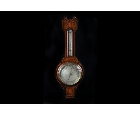 A mahogany banjo barometer,  the circular silvered register calibrated between 26 and 31", 83cm long