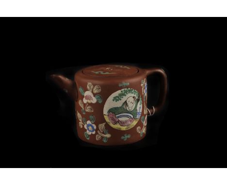 A 1920s Yixing terracotta tea pot, decorated with glazed flowers, seal mark to base, 9cm high, finial snapped off