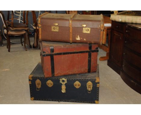 A group of three vintage travel trunks, including a brown painted tin example, a blue covered card case and a brown trunk (3)