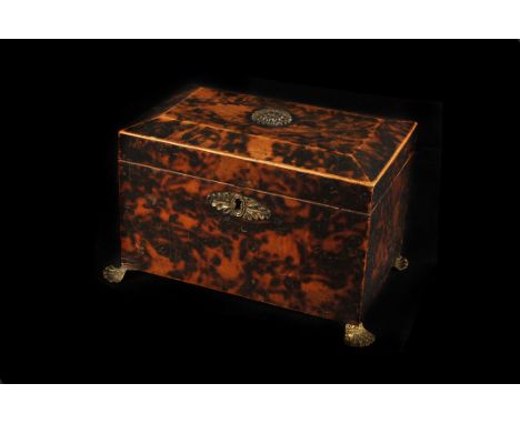 A Georgian tortoiseshell-effect tea caddy, of rectangular form, with brass mounts and feet, with two-compartment interior, 20