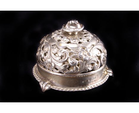 A late Victorian silver service bell, Birmingham 1900, pierced and chased with foliate scrolls, 8cm diameter
not functioning,