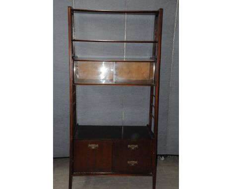 A 1960s bookcase unit, having ladder supports with glazed bookcase / display compartment section, two shelves, above two draw