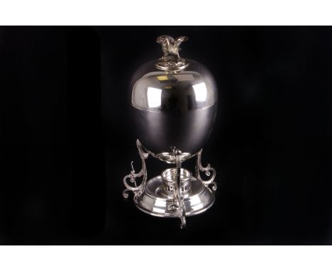 A silver plated egg waiter,  with eagle finial, 24cm high