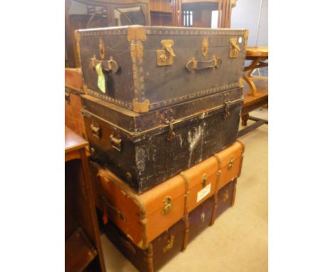 A collection of four trunks,   comprising two wooden banded university truck, a metal uniform trunk, and a university truck w