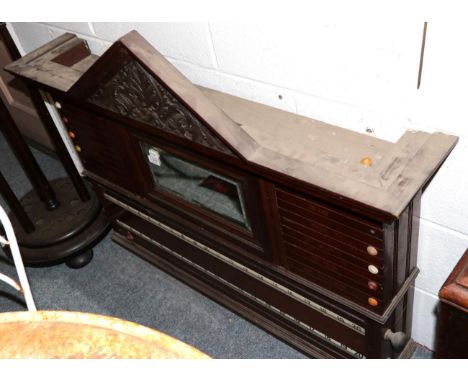 ~ A late Victorian mahogany single scoreboard with a carved architectural pediment above a bevelled glass mirror, 107cm by 87