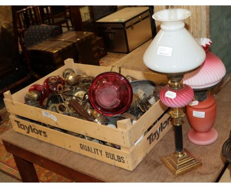 A pink satin glass oil lamp and shade; together with other lamps and plates 