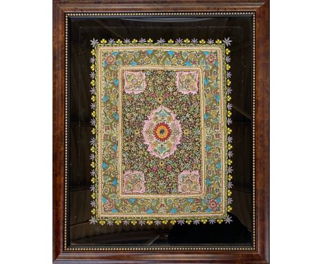 A framed 20th century Indian Zardozi embroidered jewel carpet wall hanging, black velvet embroidered with metallic thread and