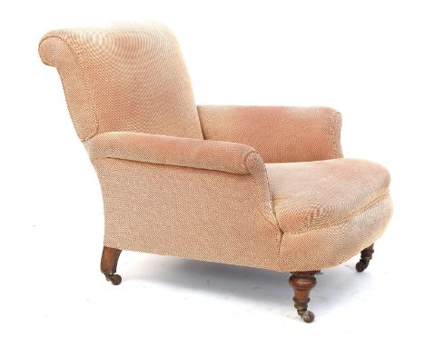 A good Howard type armchair, on turned front legs with ceramic casters, the back leg number stamped, 81cm wide