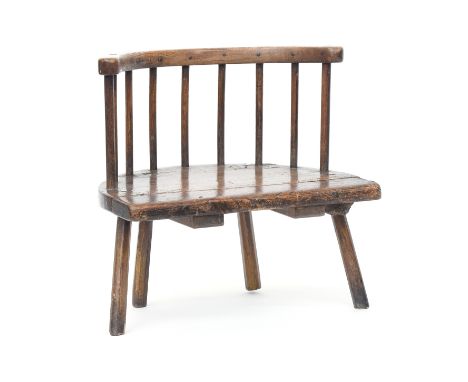 A Welsh primitive ash stick chair, with a curved rail over a solid seat, on drawn legs, 59cm wide, the seat 28.5cm high