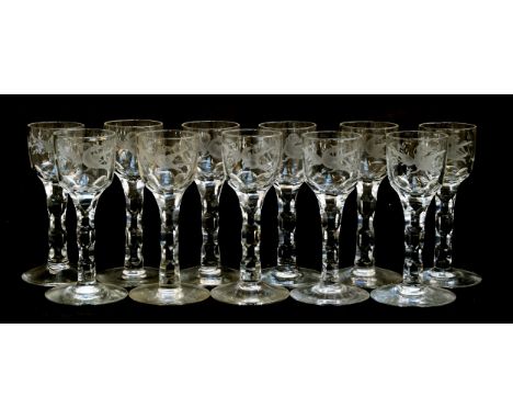 A set of eleven 19th century engraved and cut glass stemmed sherry glasses, the bowls engraved with ho-ho birds and flowers, 
