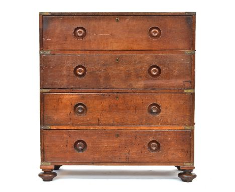 A 19th century teak campaign chest, in two parts, comprising a secretaire drawer over three long drawers, with turned flush h