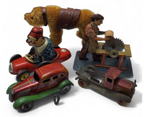 A Joustra tinplate tinplate clockwork Bimbo the Clown in race car, missing key (af); a Steiff style bear on wheels; an Arnold