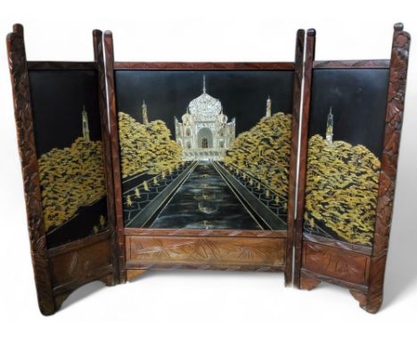 Orientalism - an early 20th century lacquered three fold fire screen decorated with The Taj Mahal in mother of pearl c.1920