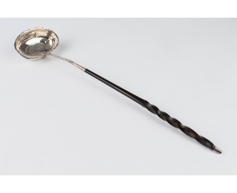 A George IV silver toddy or punch ladle - London 1825, maker's mark rubbed, with chased foliate rosette, baleen handle, 35.5 