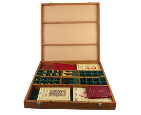 A custom-made chess boxset, the board secured by toggle-latches and serving as a lid. The interior fitted with individual com