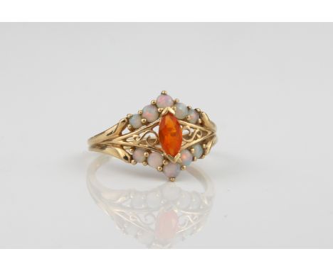 A 9ct gold. white opal and fire opal cluster ring&nbsp; - the central marquis cut fire opal within a pierced S-scroll setting