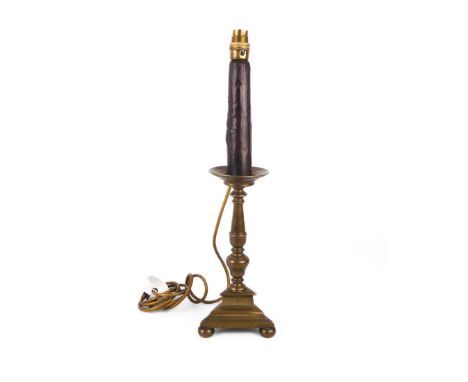 A late-18th century brass tripod candlestick adapted as a table lamp, the trainagular base marked with a shield between the l