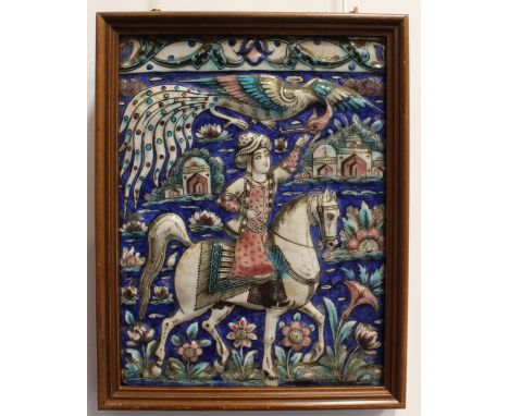 A set of four Persian Qajar moulded pottery faience glazed tiles - 19th century, each depicting a young nobleman on horseback