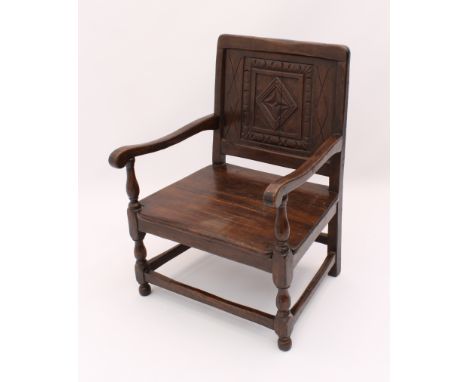 An early 20th century carved oak low armchair in 17th century style - from St Arvans House, Monmouthshire, 52.5 cm wide, 72 c