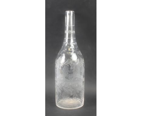A late Georgian magnum size bottle decanter - cut and wheel engraved, the body cut with fruiting vines and a central fern lea