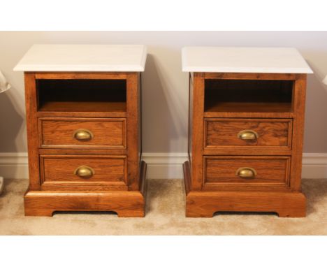 A pair of oak and marble bedside cabinets to match the previous lot - in the 19th century, with white marble tops and an open