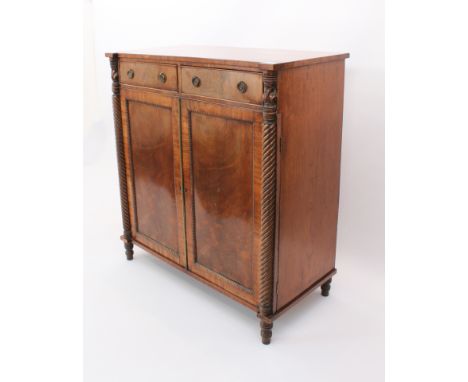 A Regency mahogany chiffonier - the rectangular top with outset front angles, on foliate carved and spiral reeded turned half