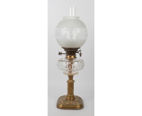 An Edwardian brass and cut glass oil lamp by Hinks &amp; Sons for Maple of London, the rounded square base repouss&eacute; de