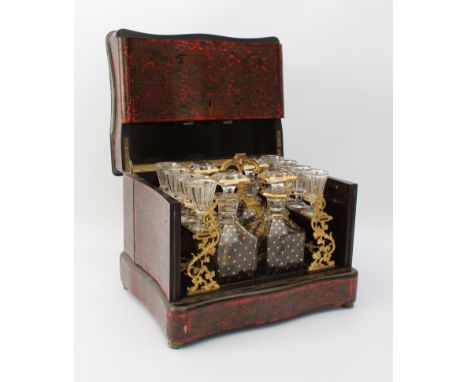An early 19th century French Boulle-style cave &agrave; liqueur or travelling decanter set - the serpentine rectangular case 