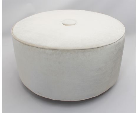 A large circular stool or pouffe by Forge House Interiors - in ivory velour with single buttoned seat, on square tapered wood