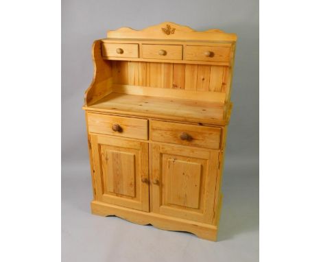 A pine chiffonier, with three small drawers over two drawers above cupboards, raised on a bracket plinth base, 95cm x 42cm x 