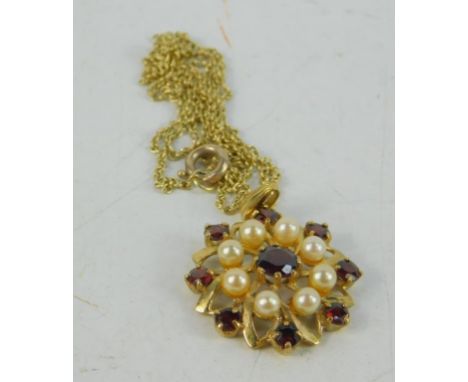 A 9ct gold garnet and seed pearl floral pendant on chain, 5.5g.