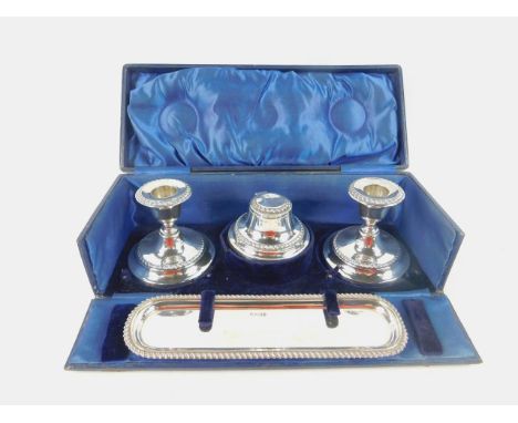 An Edward VII gentleman's four piece travelling desk set, comprising a pair of candlesticks, inkwell and pen tray, cased, She